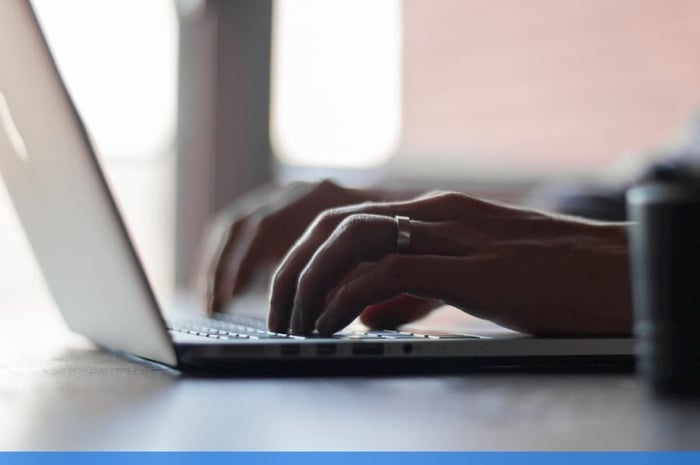 Man writing on mac laptop