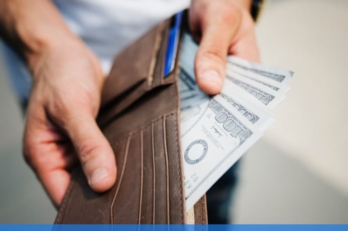 Man taking dollar bills from a wallet