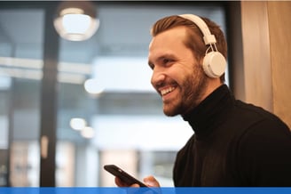 young man using bluetooth headphones